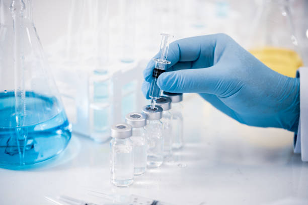 A laboratory technician preparing poultry vaccine vials