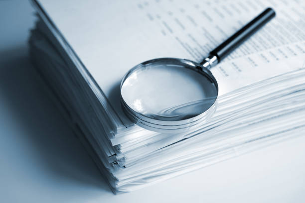 Magnifying glass over export documents during shipment timeline planning