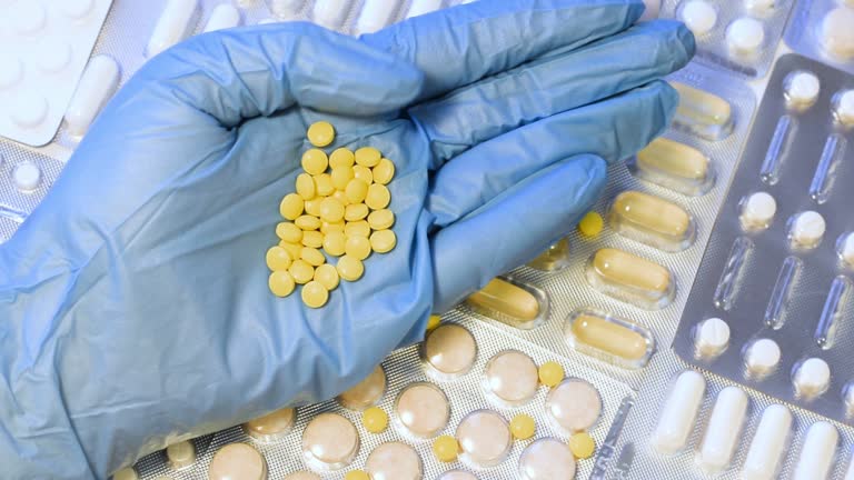 Different antibiotic medicines displayed on a medical gloved hand
